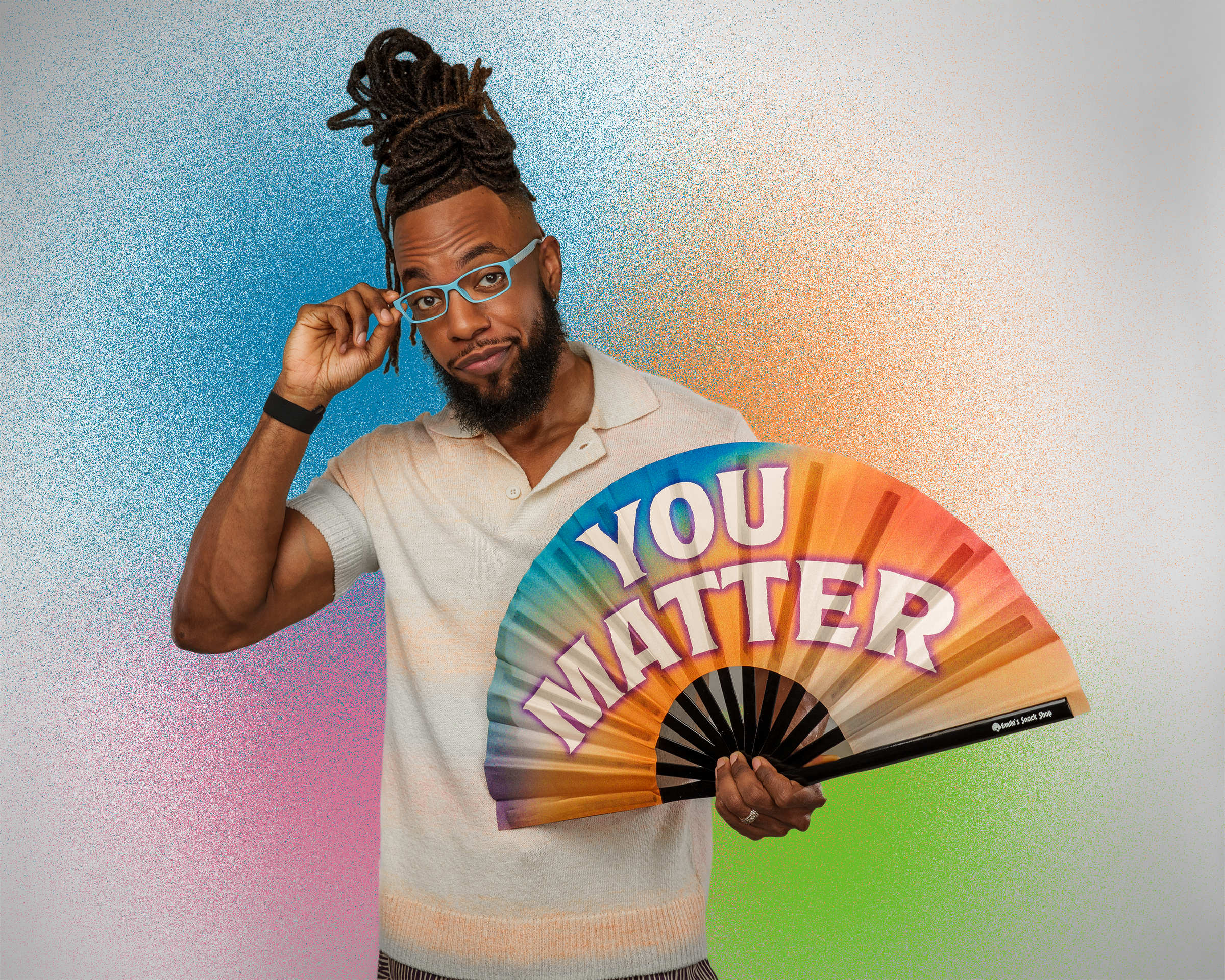 Man holding a colorful fan with 'YOU MATTER' text against a gradient background