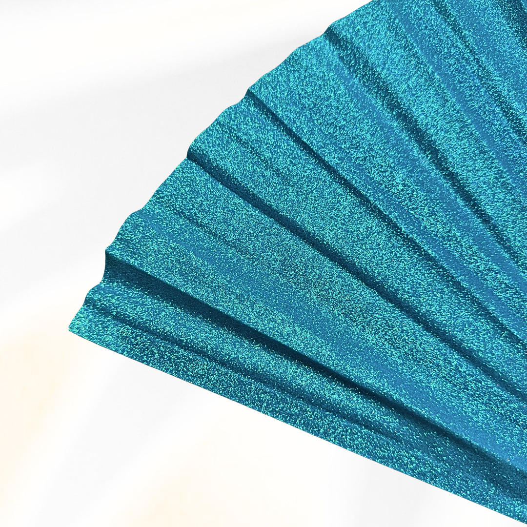 A close-up of a glittery teal blue pleated fan or fabric panel, shown against a clean white background.
